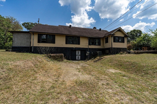 rear view of house with a lawn