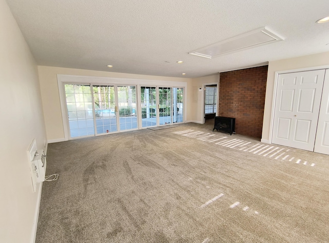 unfurnished living room with light colored carpet and a textured ceiling