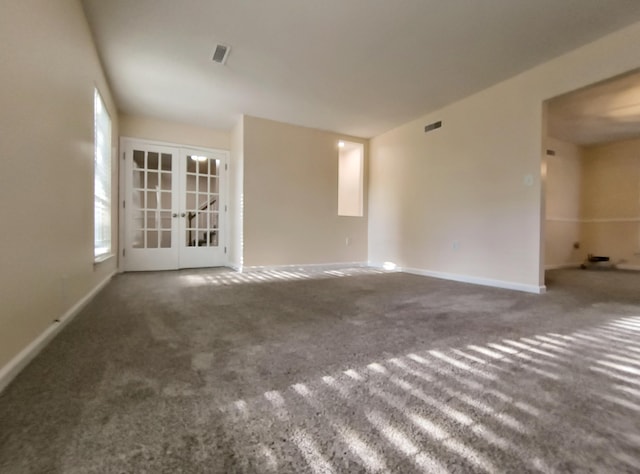 carpeted empty room featuring french doors