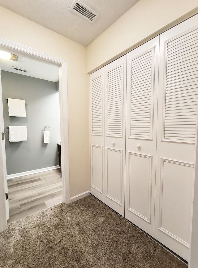 unfurnished bedroom featuring a closet and carpet flooring