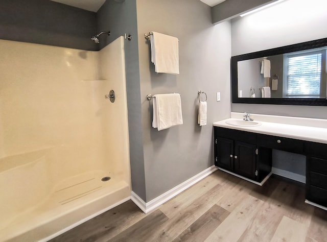 bathroom with vanity, hardwood / wood-style floors, and walk in shower