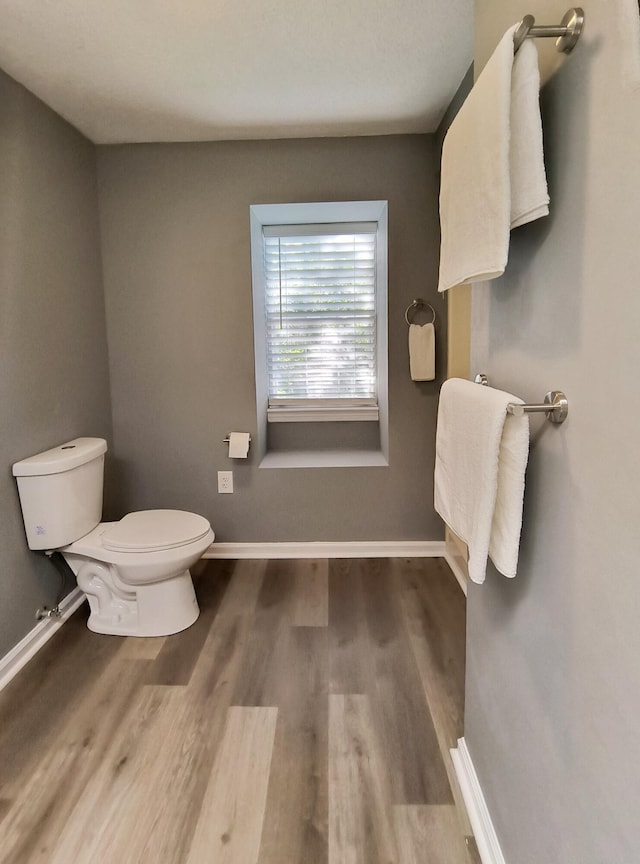 bathroom featuring hardwood / wood-style floors and toilet