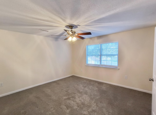 empty room with dark carpet and ceiling fan