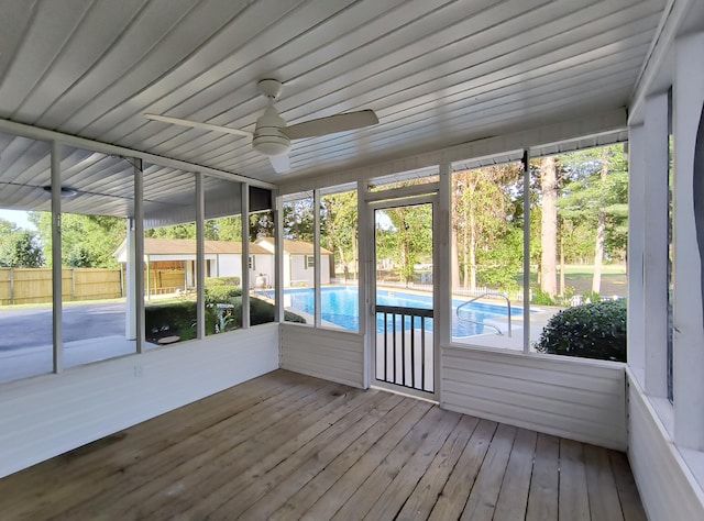 unfurnished sunroom with ceiling fan