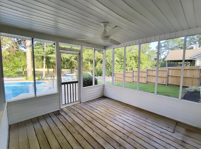 unfurnished sunroom featuring wood ceiling and ceiling fan