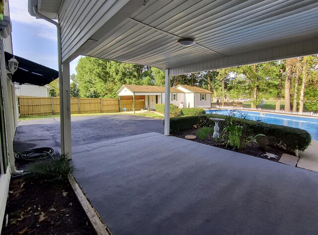 view of patio featuring an outdoor structure and ceiling fan