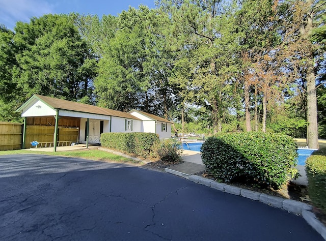 view of front of home with a fenced in pool