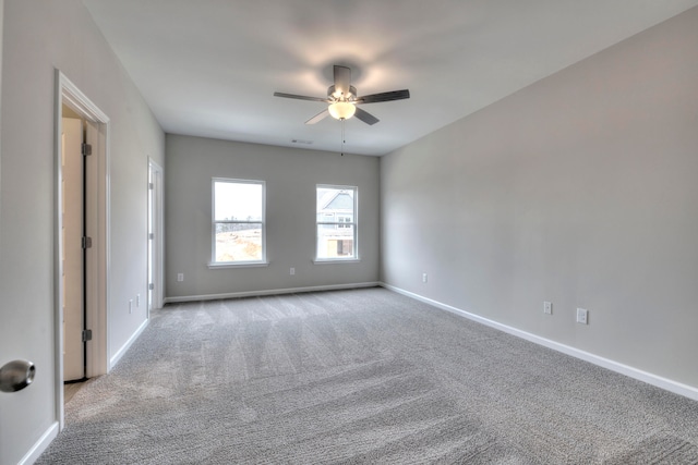 empty room featuring light carpet and ceiling fan