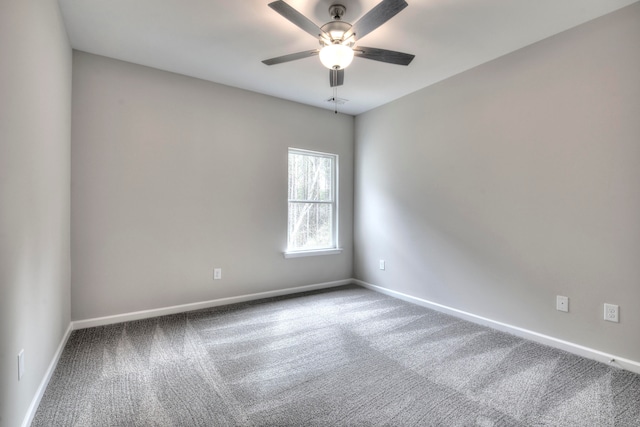 spare room with ceiling fan and carpet