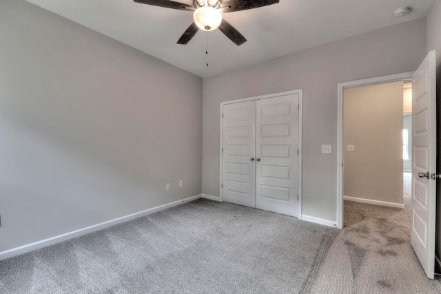 unfurnished bedroom with a closet, ceiling fan, and carpet