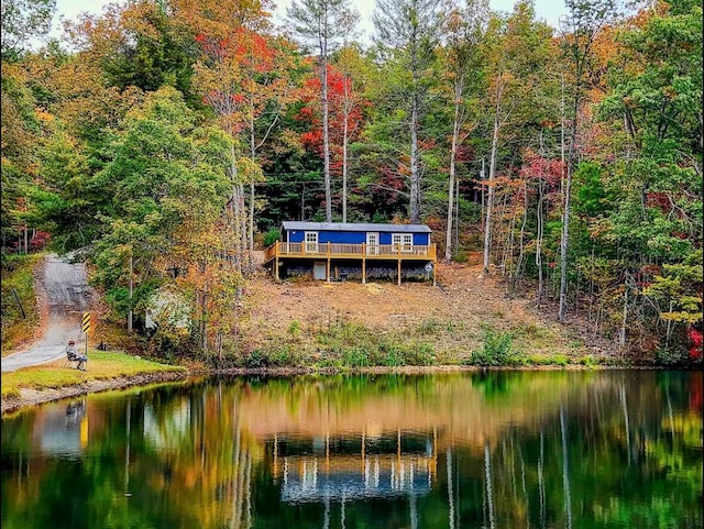 back of property featuring a water view