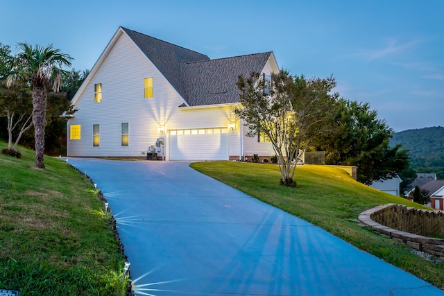 view of front facade featuring a garage and a front lawn