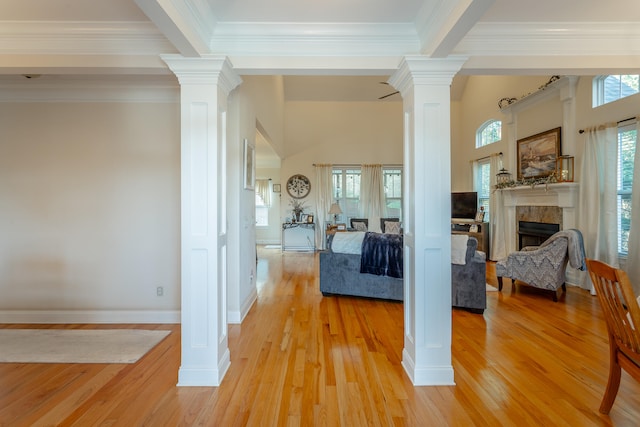 interior space with ornamental molding, ornate columns, and light hardwood / wood-style floors