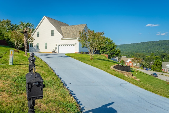 view of side of property with a lawn and a garage