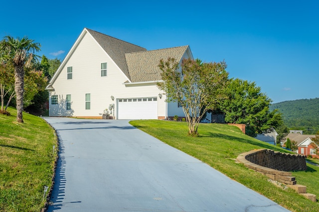 view of front facade with a front yard and a garage