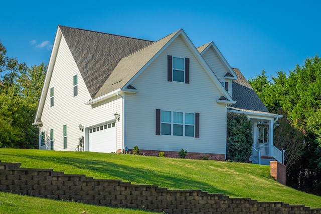 view of front facade with a garage and a front lawn