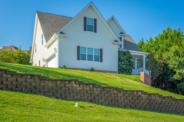 exterior space with a yard and a garage