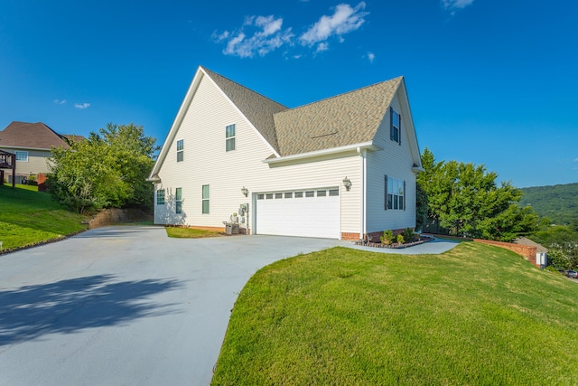 view of front of house with a front yard and a garage