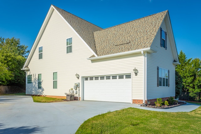 view of front of home with a front yard and a garage