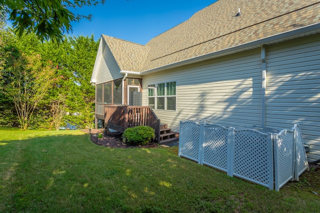 back of house with a lawn and a wooden deck