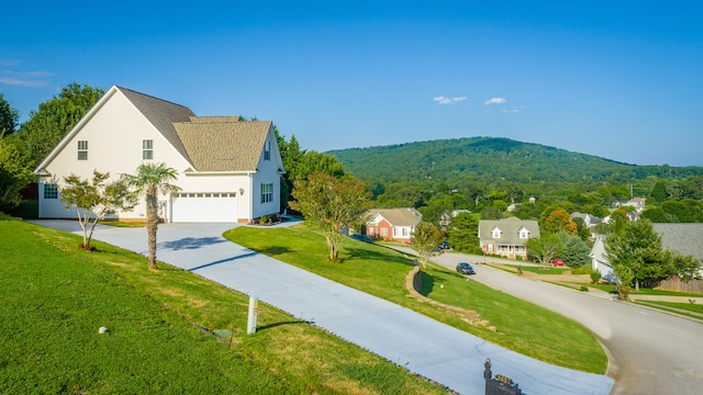 exterior space with a front lawn and a mountain view