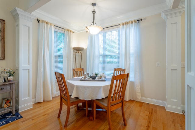 dining space featuring ornamental molding, decorative columns, and light hardwood / wood-style floors