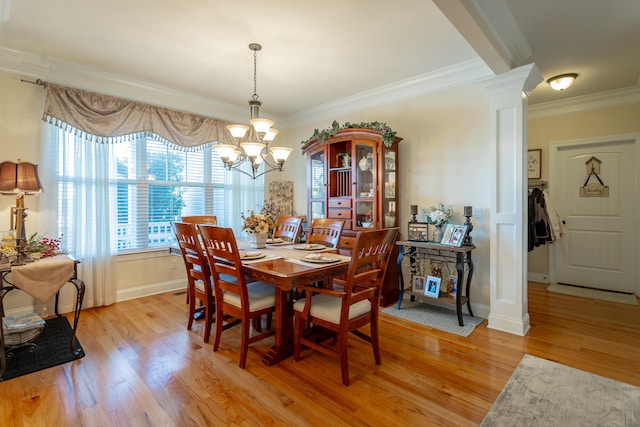 dining area with light wood-type flooring, an inviting chandelier, and crown molding