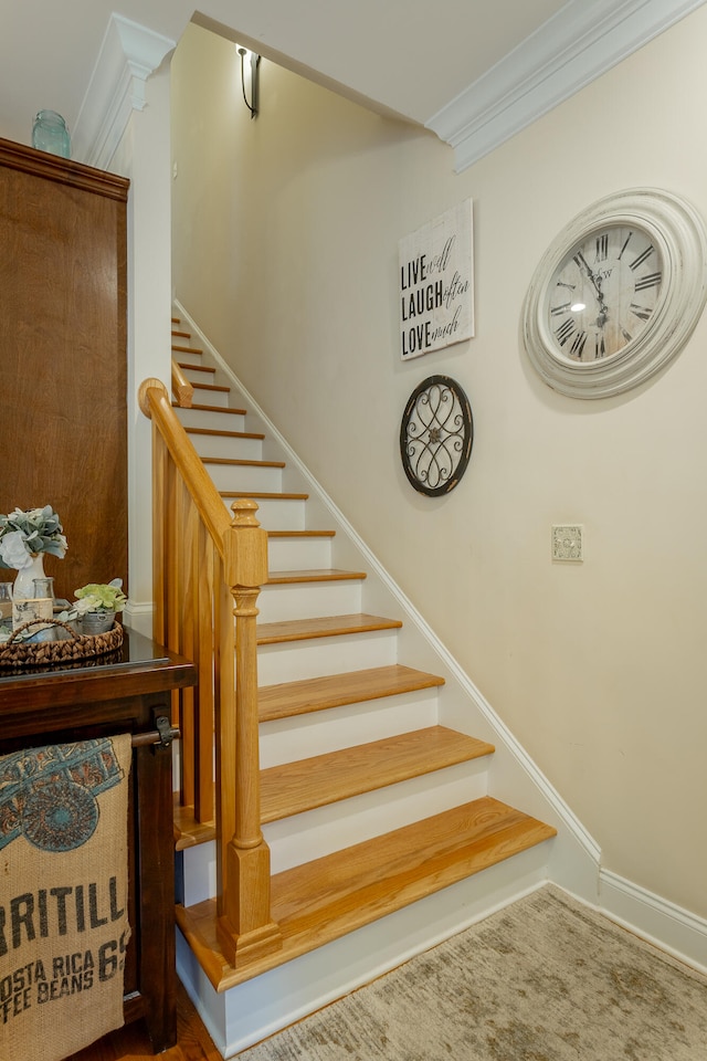 staircase featuring crown molding