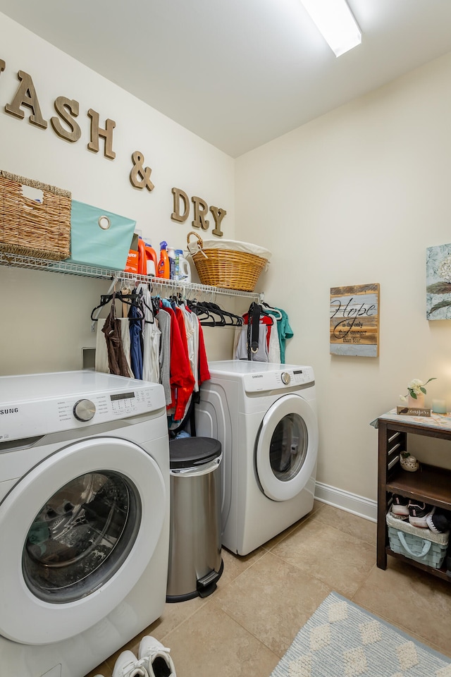 clothes washing area featuring light tile patterned floors and independent washer and dryer