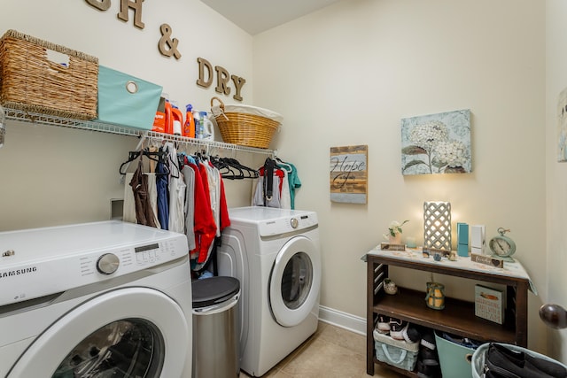 clothes washing area featuring washer and clothes dryer and light tile patterned floors