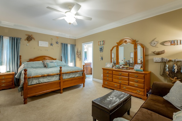 carpeted bedroom featuring multiple windows, ceiling fan, ensuite bathroom, and crown molding