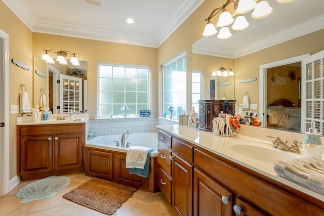 bathroom with tile patterned floors, a washtub, ornamental molding, and vanity