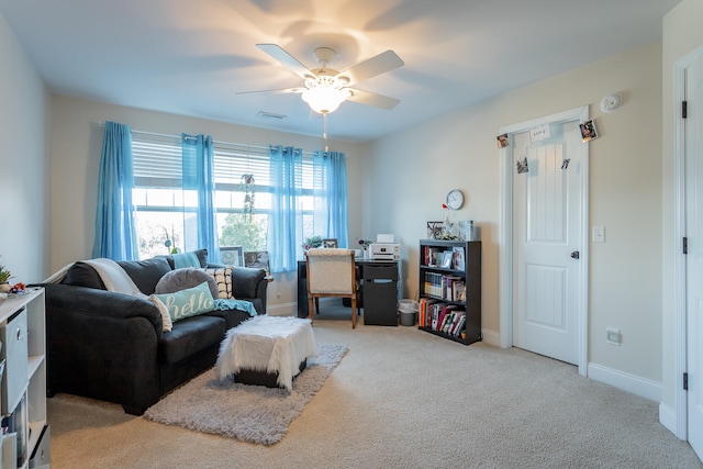 carpeted living room with ceiling fan