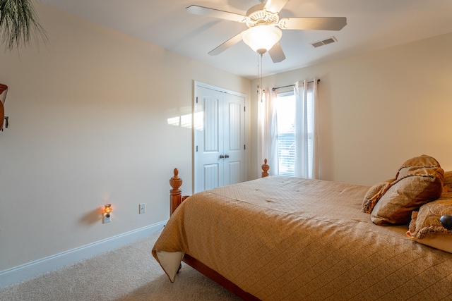 carpeted bedroom featuring ceiling fan and a closet