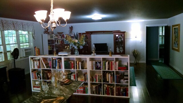 interior space with a chandelier, baseboards, wood finished floors, and cooling unit