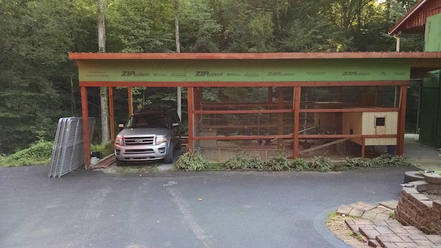 view of parking / parking lot featuring a carport and driveway