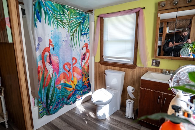 full bathroom featuring toilet, vanity, shower / bath combo with shower curtain, wood-type flooring, and plenty of natural light