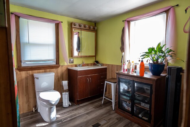 3906 Kellys Ferry Rd, Chattanooga, TN 37419 - half bathroom with wainscoting, toilet, vanity, wood walls, and wood finished floors