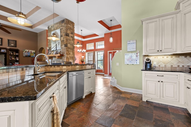 kitchen featuring ceiling fan with notable chandelier, backsplash, dishwasher, decorative light fixtures, and sink