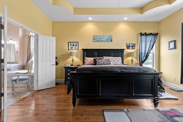 bedroom with dark hardwood / wood-style flooring