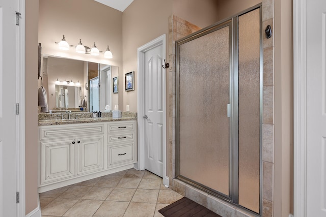 bathroom with vanity, tile patterned flooring, and a shower with door