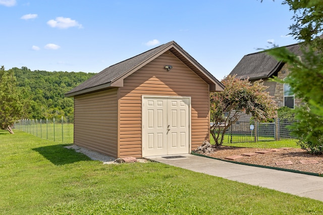 view of outbuilding featuring a lawn