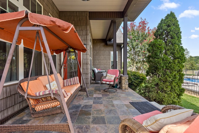 view of patio with outdoor lounge area and a fenced in pool