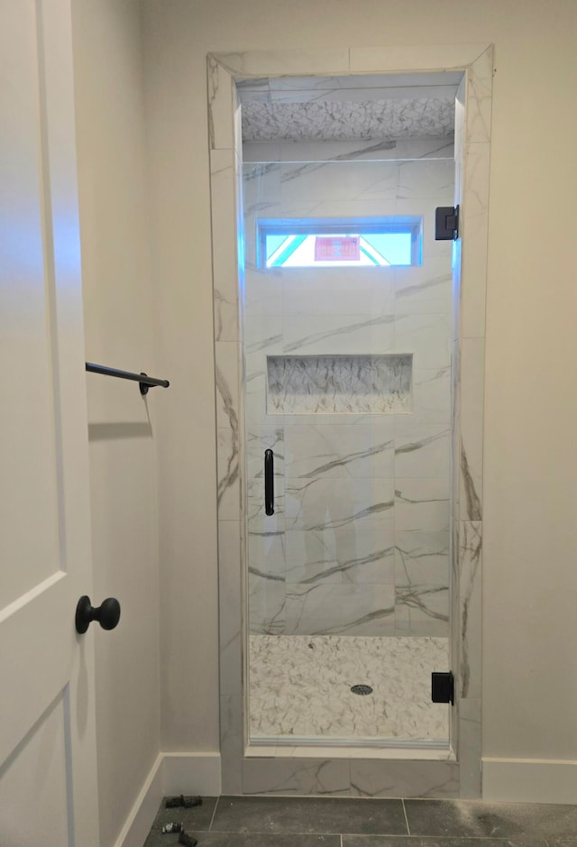 bathroom featuring a shower with door