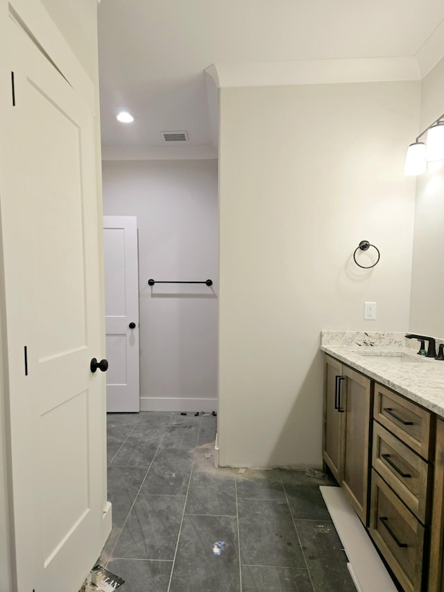 bathroom with vanity and ornamental molding