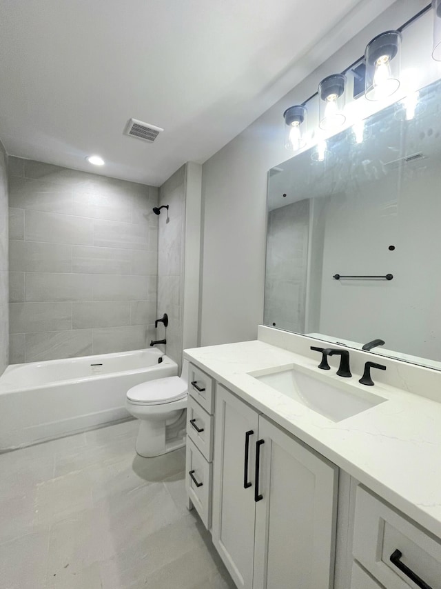 full bathroom featuring vanity, toilet, and tiled shower / bath combo