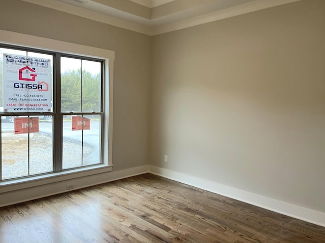 spare room featuring hardwood / wood-style floors and ornamental molding