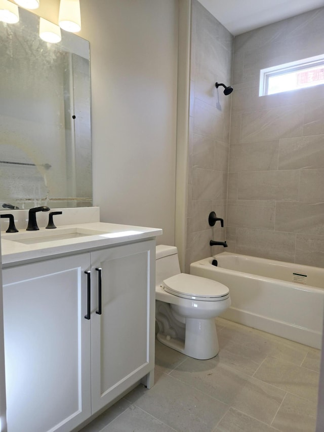 full bathroom featuring vanity, tiled shower / bath combo, and toilet