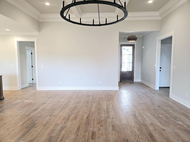 spare room with wood-type flooring and ornamental molding