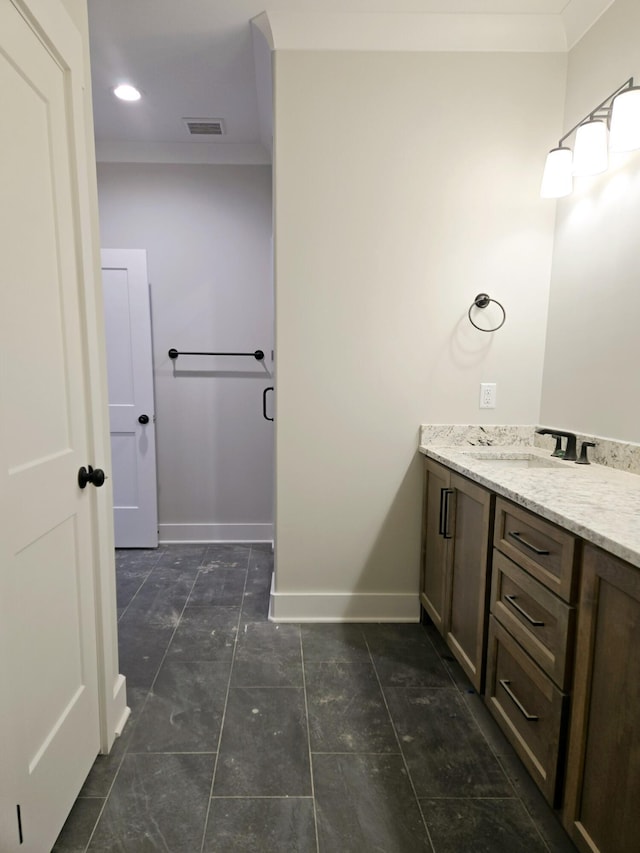 bathroom with vanity and ornamental molding